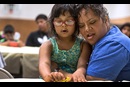 Danielle Lopez receives a hug from daughter Denise following the singing of Amazing Grace in Cherokee, North Carolina.