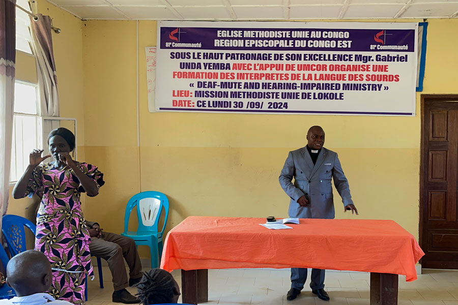 A member of Lokole United Methodist Mission in Kindu offers sign language interpretation during worship, helping make the service more inclusive. Photo by Chadrack Londe.