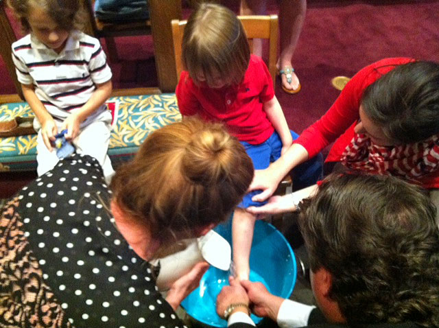Children having their feet washed during Maundy Thursday worship.