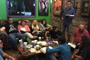 The Rev. Michael Beck (seated on the floor in a blue shirt) leads a Bible study at Tattoo Parlor Church, a Fresh Expression that has been gathering for over a decade in Ocala, Florida. Photo courtesy of Tattoo Parlor Church.