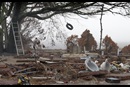 A tire swing sways in the wind from Hurricane Rita over the remains of a beachfront home destroyed by Hurricane Katrina in Ocean Springs, Miss. Rita made landfall in East Texas Sept. 24, 2005, nearly four weeks after Katrina hit Louisiana and Mississippi. Photo by Mike DuBose, UMNS.