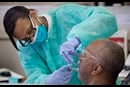 Student doctor Dionne Tompkins treats patient Reginald Hill during a clinic at the Meharry Medical College School of Dentistry in Nashville, Tenn. Photo by Mike DuBose, UMNS. 