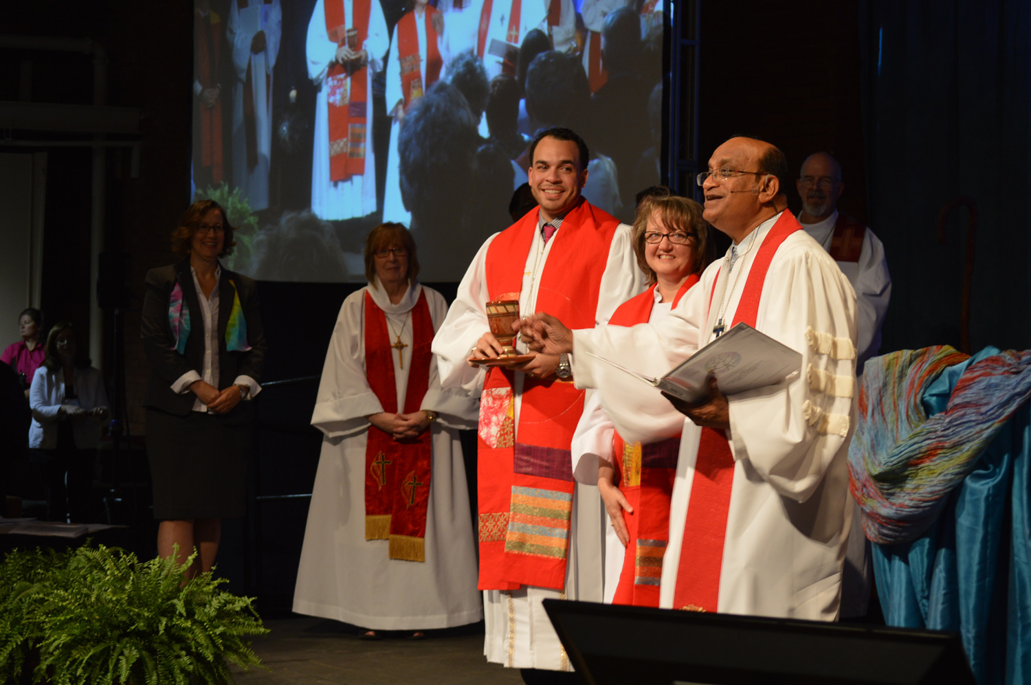 Bishop and new clergy prepare to serve communion