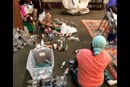 Left to Right: Amber Harrison and Celeste Vanhoose (back to camera) de-labeling and crushing plastic bottles for shredding. Photo: Mollie Erickson