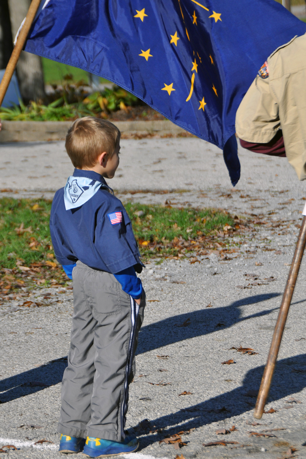 A child stands near a flag during an Operation Salute event. 