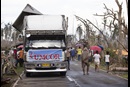 Community members walk past a food distribution site for the United Methodist Committee on Relief following Typhoon Haiyan in Dagami, Philippines. Photo by Mike DuBose, UM News.