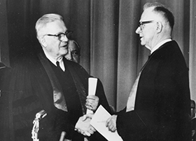 Evangelical United Brethren Church Bishop Reuben H. Mueller (left) and Methodist Bishop Lloyd C. Wicke join hands on April 23, 1968, symbolizing the merger between the two denominations. 1968 file photo courtesy of the United Methodist Commission on Archives and History.