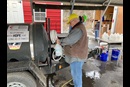 The water buffalo (left, with the UMCOR sign), filled and ready in Gary for water distribution is put through a test run. Photo courtesy of West Virginia Conference Disaster Response.