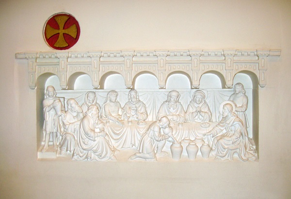 A panel on the back wall inside of Joannes de Dooper Church in Pijnacker, Netherlands, depicts the wedding feast at Cana. Photo by Hpruxpbvm, courtesy of Wikimedia Commons.