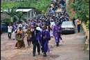 Bishop John K. Yambasu and clergy from the Sierra Leone Council of Churches lead a procession of worshippers to an area at the bottom of Mount Sugar Loaf where hundreds of bodies that were not recovered are still buried under the rubble of a devastating landslide. A service of remembrance and thanksgiving for the victims and survivors was held at the bottom of Mount Sugar Loaf, Aug. 27, 2017. File photo by Phileas Jusu, UM News.