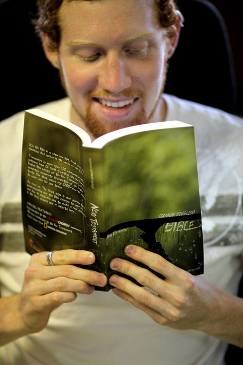 Young man reading Bible.