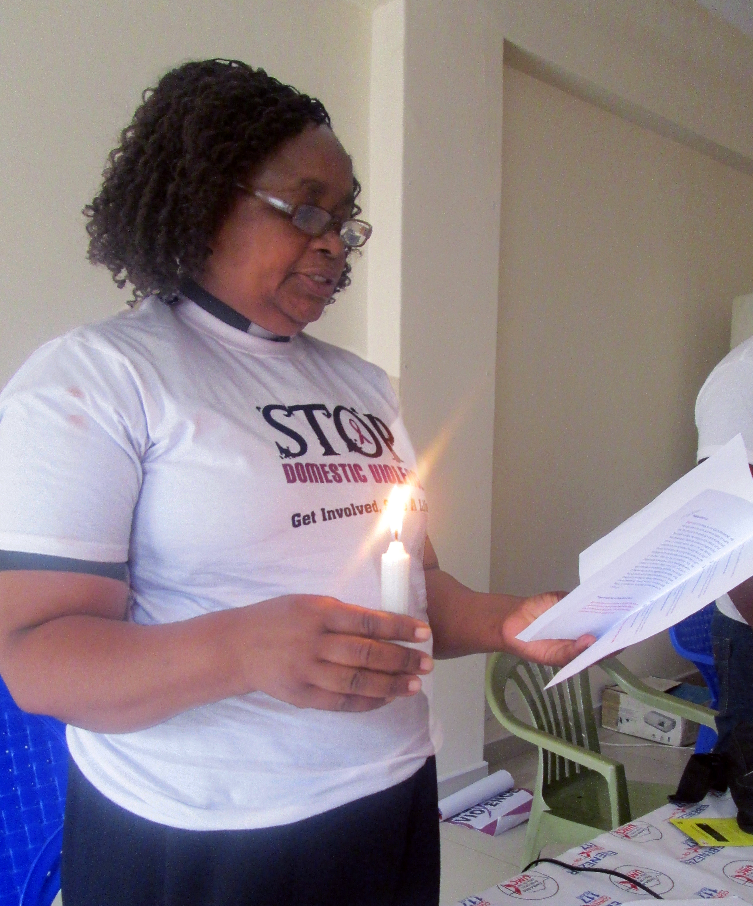 The Rev. Vienna Mutezo leads a Call to Prayer and Candlelight Vigil in memory of those affected by domestic violence at a workshop sponsored by United Methodist Women. Photo by Eveline Chikwanah