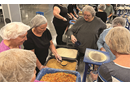 Members of our saviours and our redeemers packing food bags at feed our starving children.