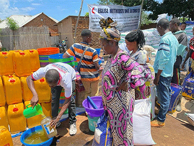 Women wait for vegetable oil at the Malicha internally displaced camp in Fizi, Congo. The United Methodist Church distributed 74 tons of supplies to survivors of two fires that ravaged the camp in August and October. The aid included rice, corn flour, salt, sugar, beans, soap, toothbrushes and more. Photo courtesy of the East Congo Episcopal Area disaster management office.