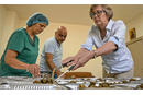 The Rev. Jane Eesley (right) helps Amal Qumsieh and Ramzi Qubrosi divide food into portions to be distributed to hungry people in the Bethlehem area by the Shepherd Society, the outreach program of Bethlehem Bible College. The program received a solidarity grant from the United Methodist Committee on Relief, helping Palestinians cope with the economic effects of the Israeli war on Gaza, which has scared away the tourists who are the motor of Bethlehem's economy. Photo by Paul Jeffrey, UM News.