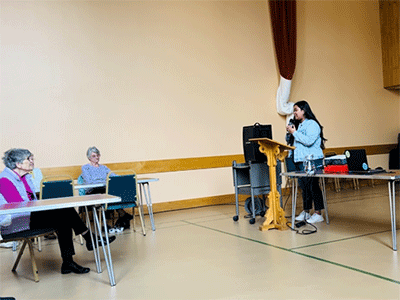 Camille Manangan (standing), speaking at the Clooney Hall elders meeting. (Photo: Courtesy of Camille Manangan)