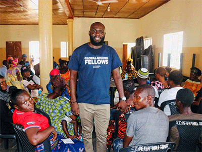 Sam Yav (standing) meets with a group that seeks to understand how climate change impacts their lives and what they can do about it. (Photo: Courtesy of Sam Yav)