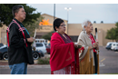 Bishop David Wilson (left) and the Rev. Donna Pewo (center) of The United Methodist Church’s Oklahoma Indian Missionary Conference join with Native American scholar Henrietta Mann in a prayer service for immigrant children held at the Casa Padre detention center, visible behind them, in Brownsville, Texas, in 2018. File photo by Mike DuBose, UM News.