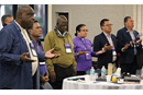 United Methodist bishops from the Philippines, Africa and the U.S. pray during morning worship Nov. 6. Photo by Rick Wolcott, Council of Bishops.