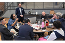 David Scott (standing), senior director of mission theology and strategic planning for the United Methodist Board of Global Ministries, listens to members of the Connectional Table discuss colonialism Oct. 24 during orientation training in Dallas. Photo by Jim Patterson, UM News.