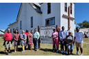 Terri Leone (2nd from left )and Drew classmates visit Rev. Calvin Hill (left of the church sign) at Browning UMC in Montana