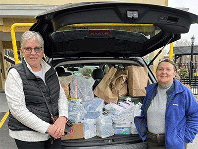 Photo of the first carload of supplies delivered to the migrants who were housed at the Orbitz Hotel in Somerset, MA (Jane Larsen on the left and Christine Pettine on the right. (Photo: Courtesy of Somerset UMC in Springfield, Mass.)