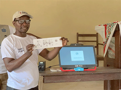 Jean Tshomba demonstrates the procedure for voting during an educational program at Victor Wetchi United Methodist Church in the Kibombo District in Congo. Tshomba is coordinator of the local disaster management office. Financial support from the United Methodist Committee on Relief helped fund a program to prevent election-related violence. Photo by Chadrack Tambwe Londe, UM News.