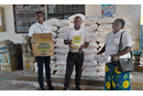 The Rev. Caleb Mbaz (left), coordinator of the Disaster Management Office for the South Congo Episcopal Area, carries a box containing vegetable oil for inmates at Kasapa Central Prison near Lubumbashi, Congo. Joining him are Disaster Management team members Kasongo Kilundu Olivier and Louise Tshiwengo. The United Methodist Church in Southern Congo distributed more than 16 tons of food and other supplies to the prison with support from the United Methodist Committee on Relief. Photo by Christian Kasweka, UM News.